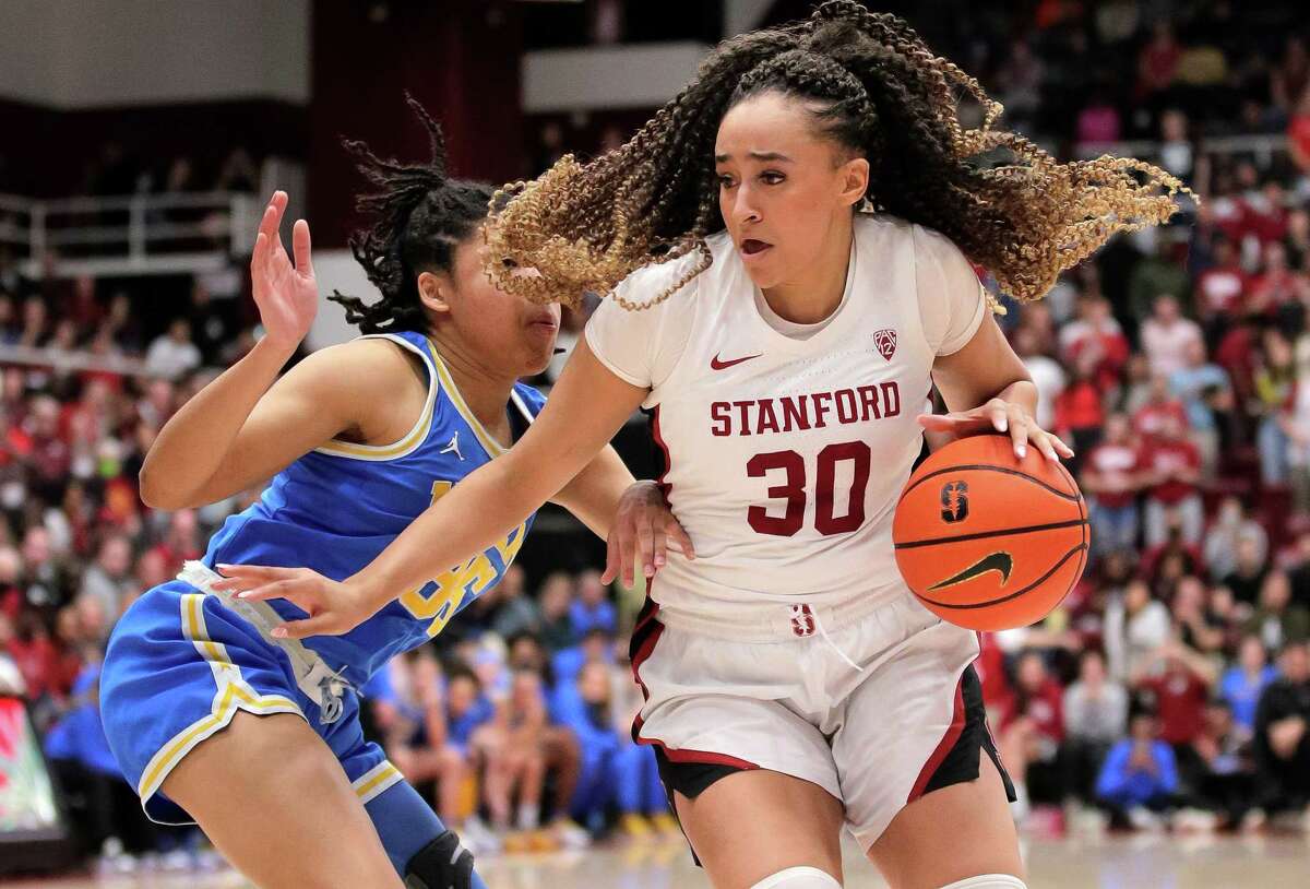 Haley Jones (30) drives around Camryn Brown (35) In the second half as the Stanford Cardinal women played the UCLA Bruins at Maples Pavilion in Stanford, Calif., on Monday, February 20, 2023.