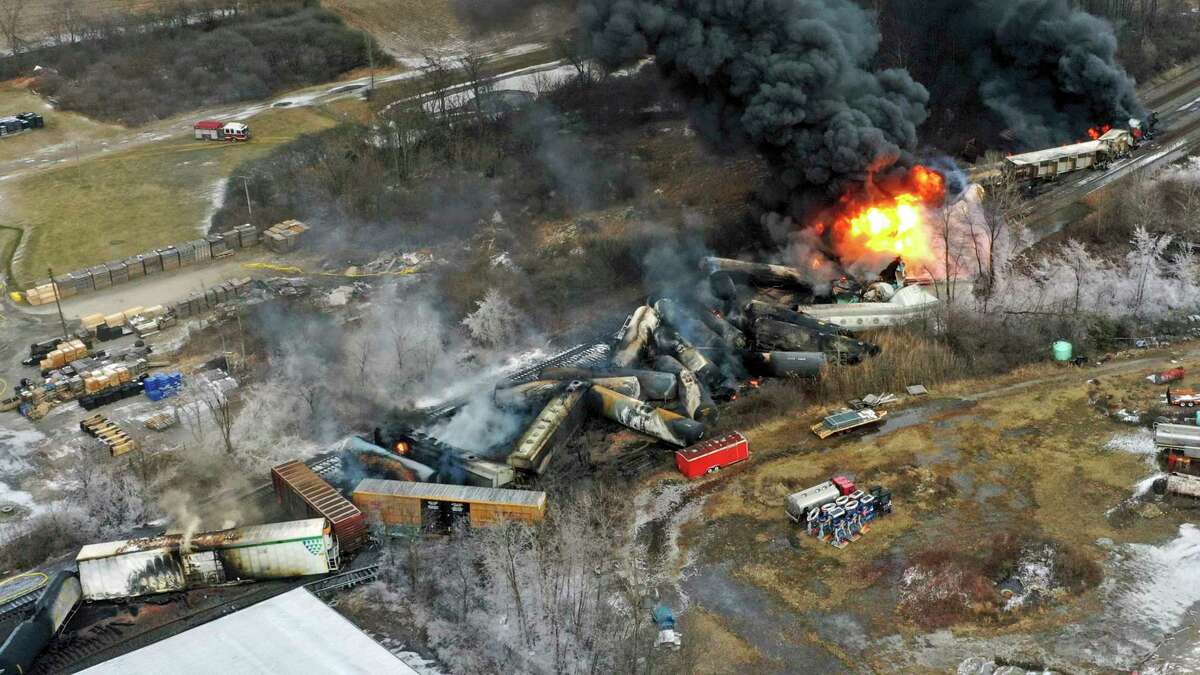 Portions of a Norfolk Southern freight train that derailed the previous night in East Palestine, Ohio, remain on fire at midday on Feb. 4. 