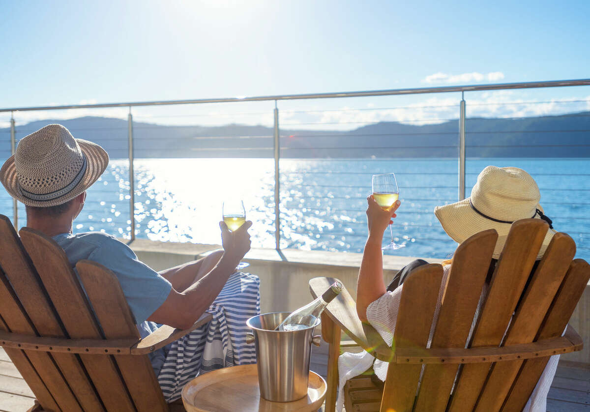 Couple relaxing and drinking wine on a cruise. 