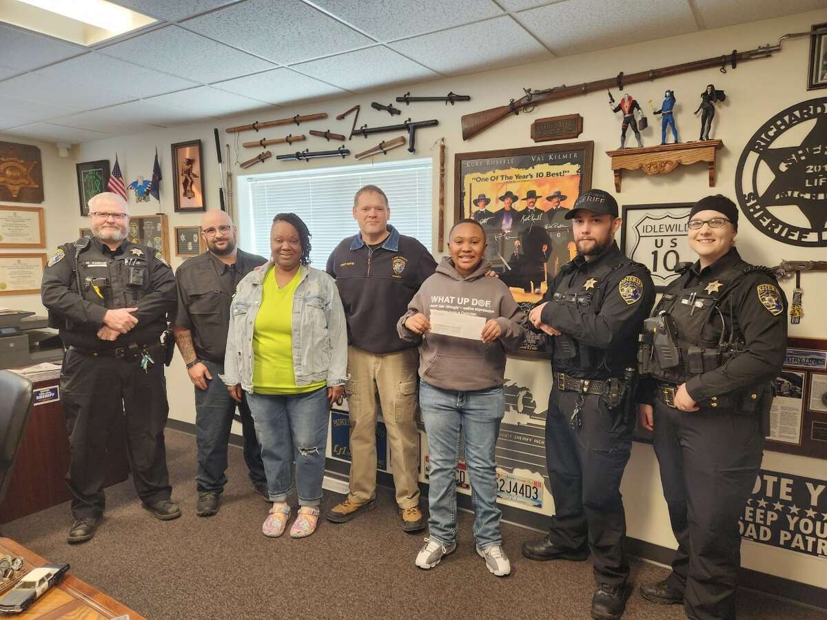 Lake County Sheriff Rich Martin presented a check for $1,000 to Blue Lake Arts Camp to assist with student tuition for Rylan Abraham-Arnold (center, holding check).