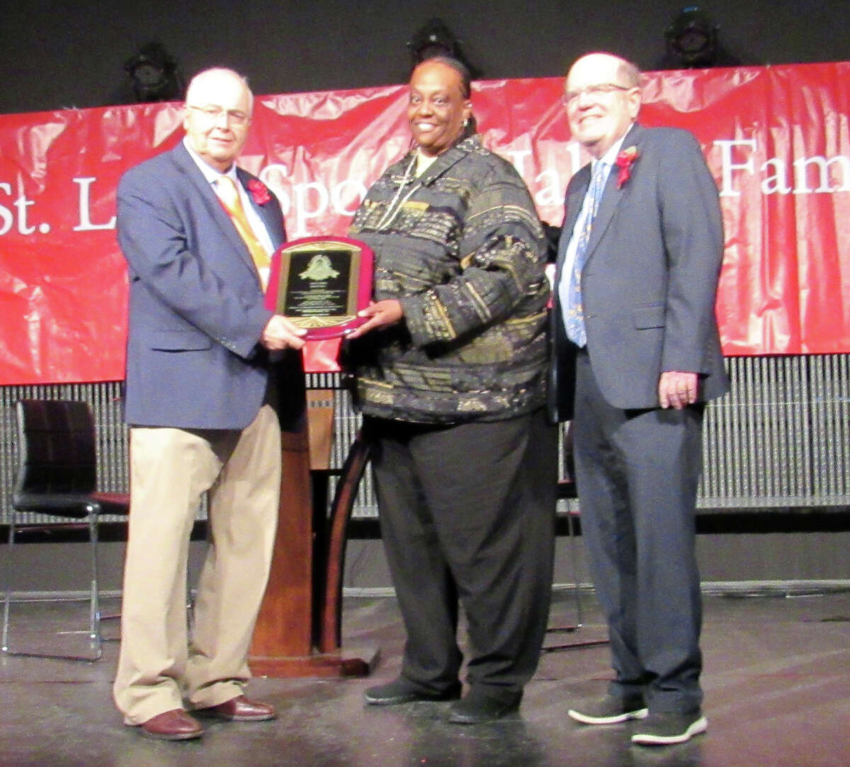 Former Alton High basketball great Cathy Snipes, center, receives her St. Louis Sports Hall of Fame award from Hall of Fame director Tim Moore, left, on Monday night at the annual Hall of Fame induction banquet in O'Fallon. Also pictured is former Telegraph sports editor Steve Porter,who received the Greg Maracek Award for Media.