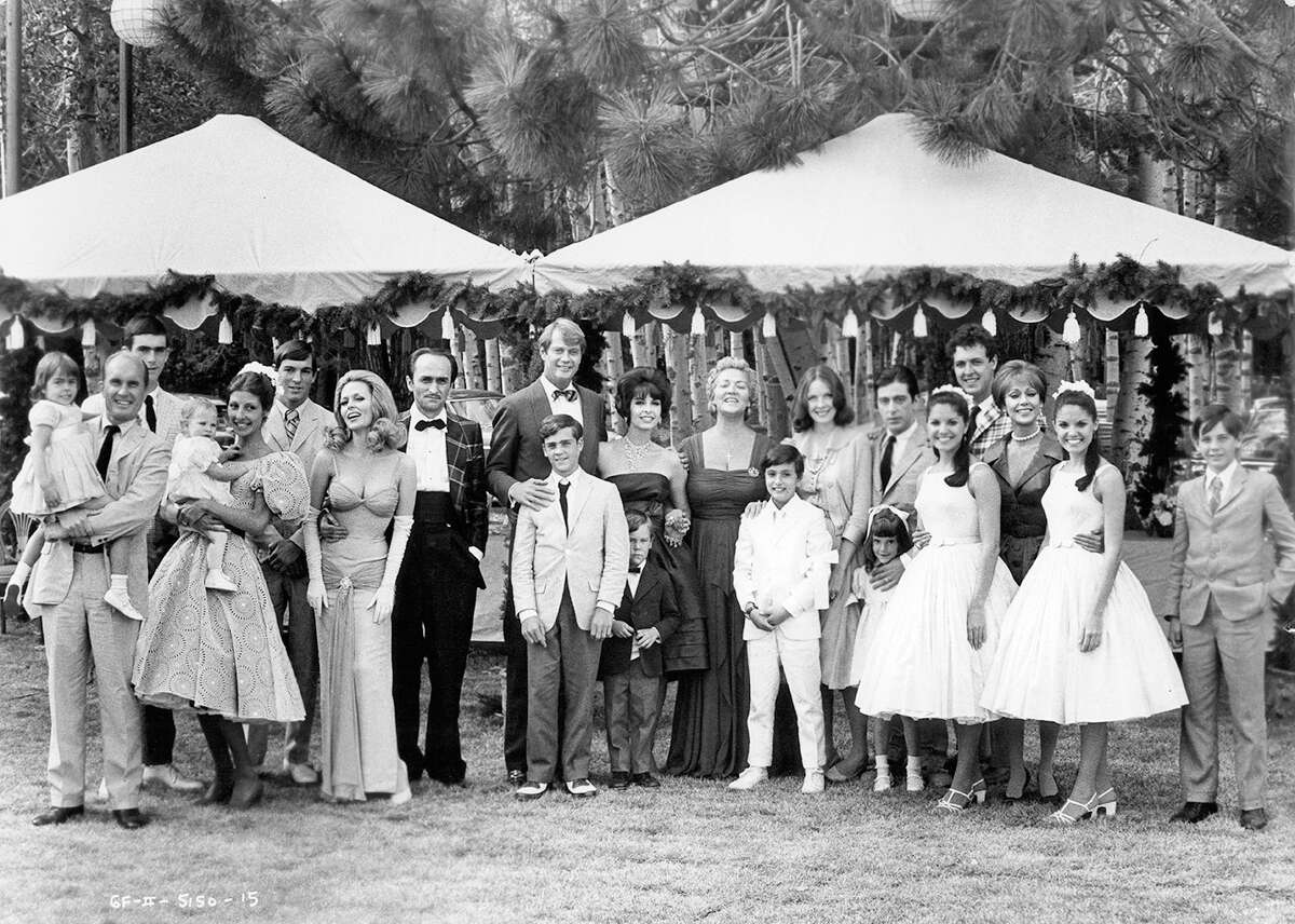 Group photo of a portion of the cast in a scene from the film "The Godfather Part II."