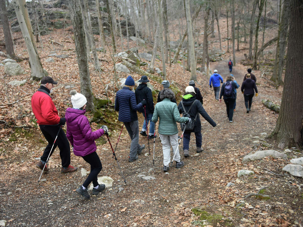 Hikers enjoy a winter walk through Mianus River Park on the border of Stamford and Greenwich, Conn. Tuesday, Feb. 21, 2023. The Friends of Mianus River Park and the Greenwich Land Trust led a winter walk to show hikers the natural and historical features of the park.