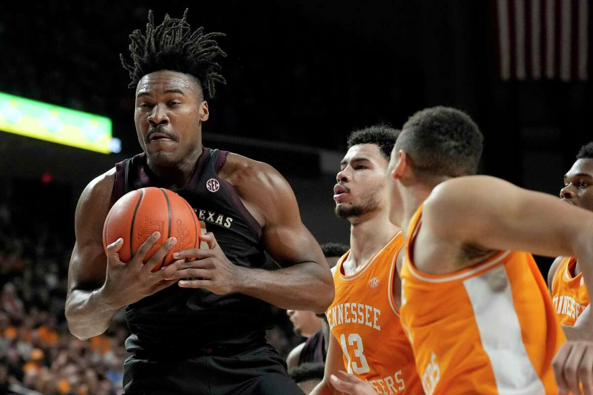 Texas A&M forward Julius Marble grabs a rebound against Tennessee players, including Olivier Nkamhoua (13), during the first half of an NCAA college basketball game Tuesday, Feb. 21, 2023, in College Station, Texas. (AP Photo/Sam Craft)