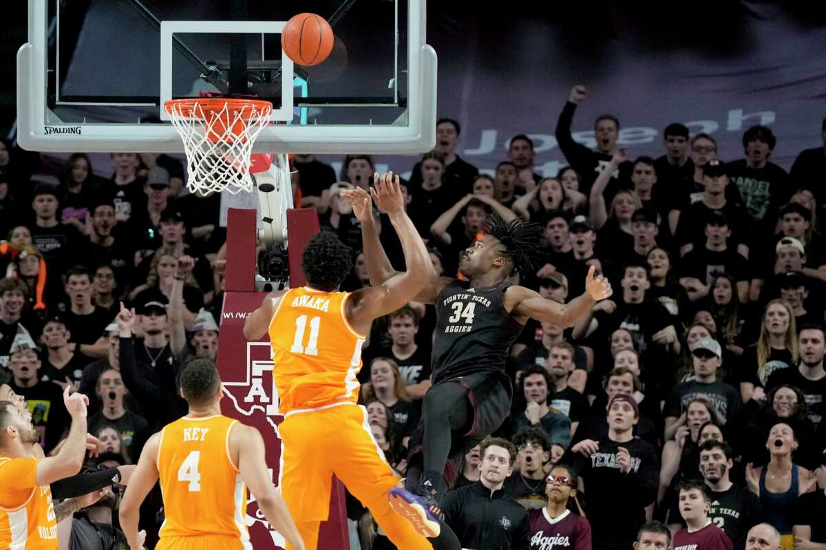 Texas A&M forward Julius Marble (34) is fouled by Tennessee forward Tobe Awaka (11) on a shot during the first half of an NCAA college basketball game Tuesday, Feb. 21, 2023, in College Station, Texas. (AP Photo/Sam Craft)