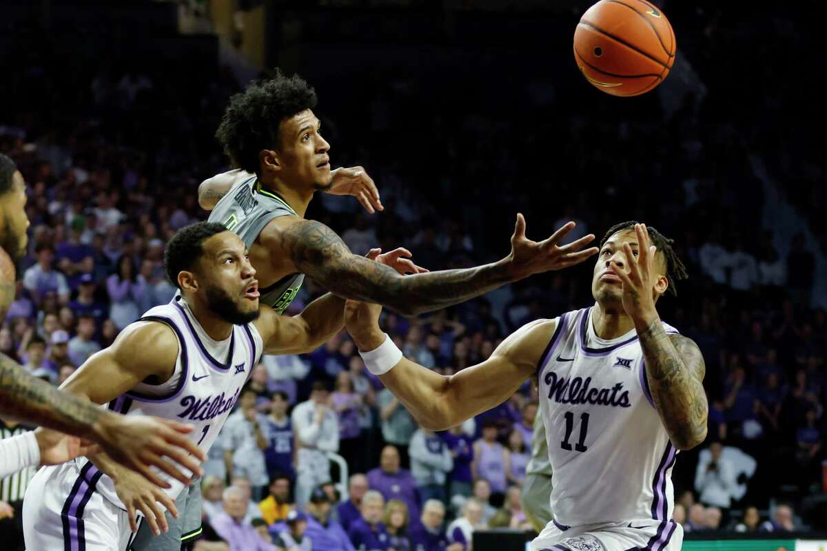 Baylor's forward Jalen Bridges, top, Kansas State guard Markquis Nowell (1) and Kansas State forward Keyontae Johnson (11) go after a loose ball during the first half of an NCAA college basketball game, Tuesday, Feb. 21, 2023, in Manhattan, Kan.