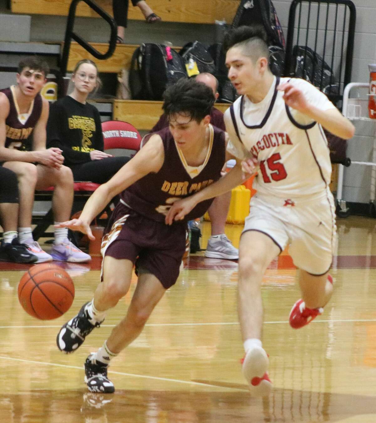   Deer Park's Andrew Aguilar crosses the mid-court stripe despite the defense of Atascocita's Luke Martinez during first-half action Tuesday night.
