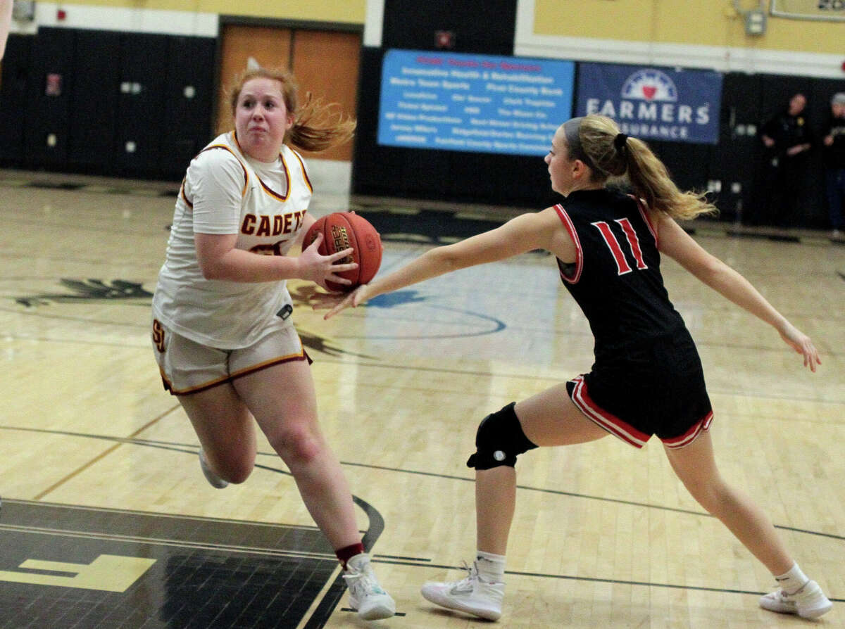 St. Joseph's Erin Donegan (25) drives the ball to the basket as Fairfield Warde's Emily Dowd (11) tries to disrupt her during FCIAC girls basketball semifinals action in Trumbull, Conn., on Tuesday February 21, 2023.