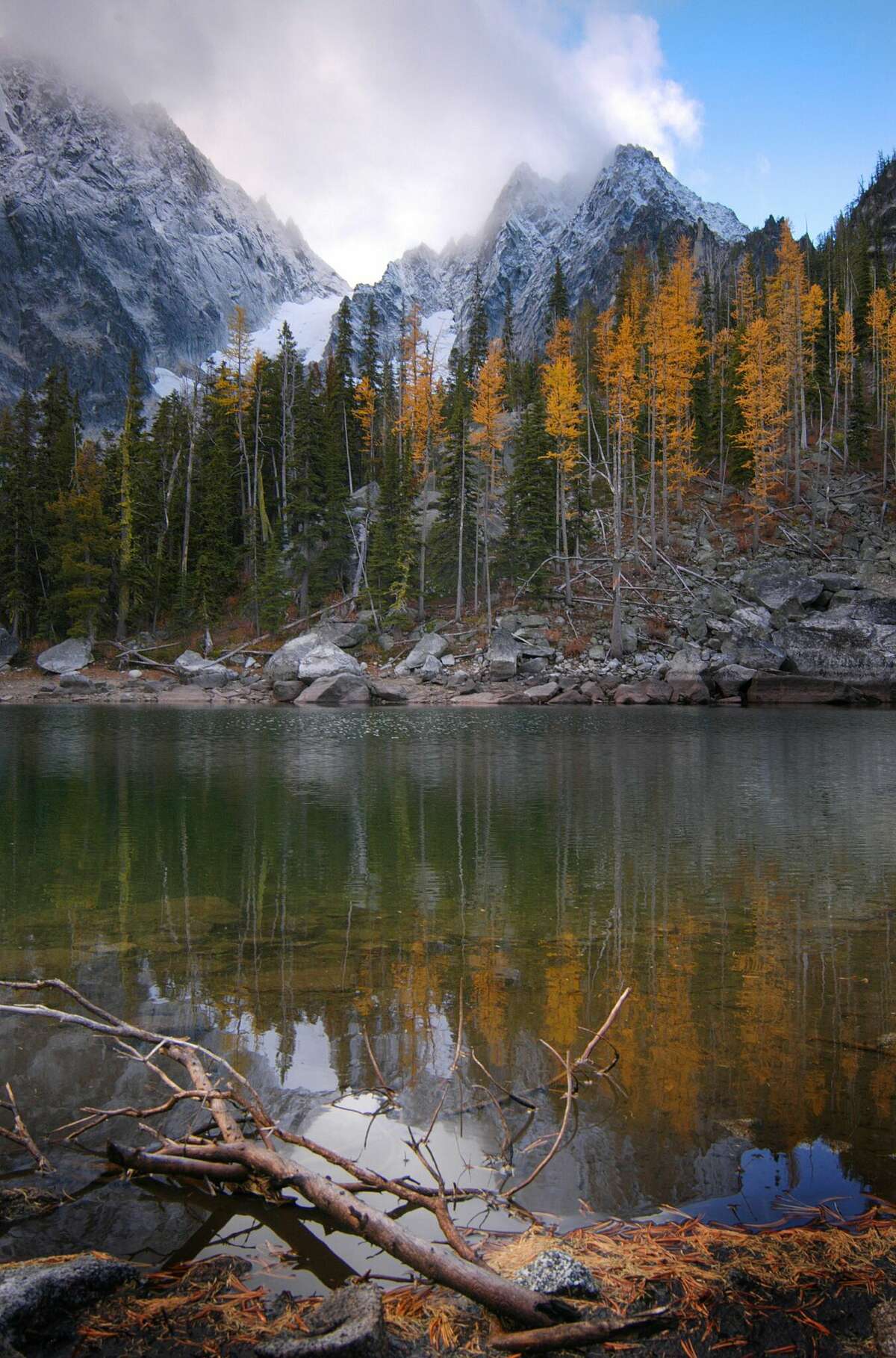 FILE PHOTO: A reflection of Colchuch Peak in Colchuck Lake near The Enchantment Lakes wilderness in Washington. A 53-year-old Connecticut man was among three climbers killed Sunday in an avalanche in central Washington, officials said.