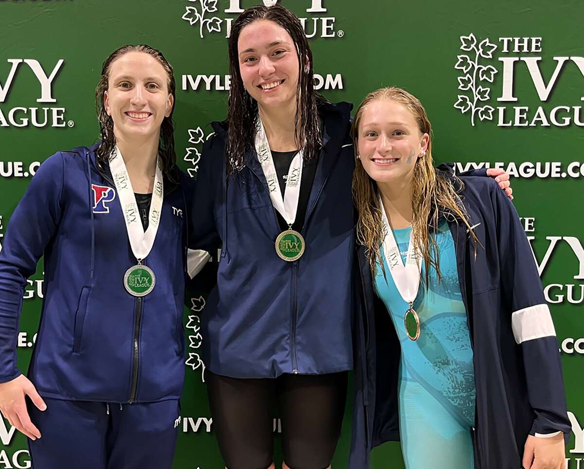 Penn's Anna Moehn, right, joins teammates junior Catherine Buroker, left and senior Anna Kalandadze, center, after the three finsihed 1-2-3 in the 500-yard freestyle at the Ivy League Championships at Princeton, with Kalandadze first and Buroker, second. Moehn is a freshman from Alton.