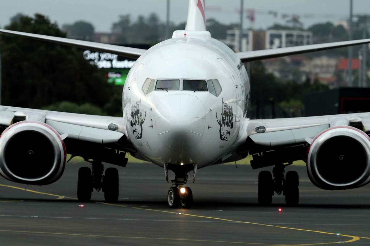 A Boeing Co. 737 aircraft operated by Virgin Australia Holdings Pty Ltd. at Sydney Airport in Sydney, Australia, on Wednesday, Feb. 8, 2023. Virgin Australia is considering taking on new debt to hand cash to owner Bain Capital just months ahead of the airline's prospective initial public offering, according to people familiar with the matter.