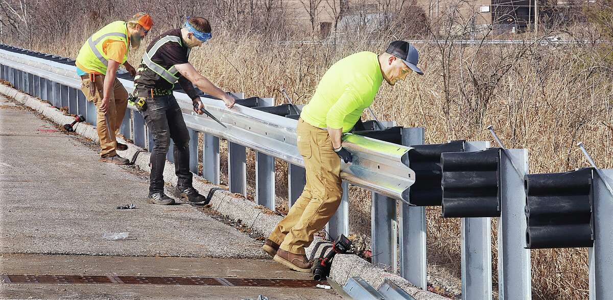 A large crew of workers were replacing the guardrails they removed Tuesday on Illinois 143 in Alton and on the Broadway Connector. Crews removed all of the old guardrails and replaced the posts holding them as well. The old guardrails connected to the posts by steel brackets or blocks of wood. The new railing connectors are made of a rigid plastic which will give and under extreme forces break away so that hitting the guardrail does not make a crash even worse.