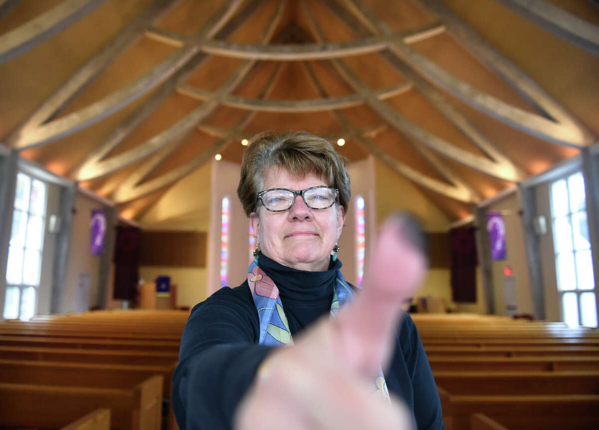 The Rev. Laura L. Galbraith demonstrates giving ashes at the United Methodist Church of Darien in Darien, Conn. Wednesday, Feb. 22, 2023. The church offered an in-person ash service in Rowayton and Darien as well as an online Zoom meditation for its congregants to mark Ash Wednesday, the start of Lent.
