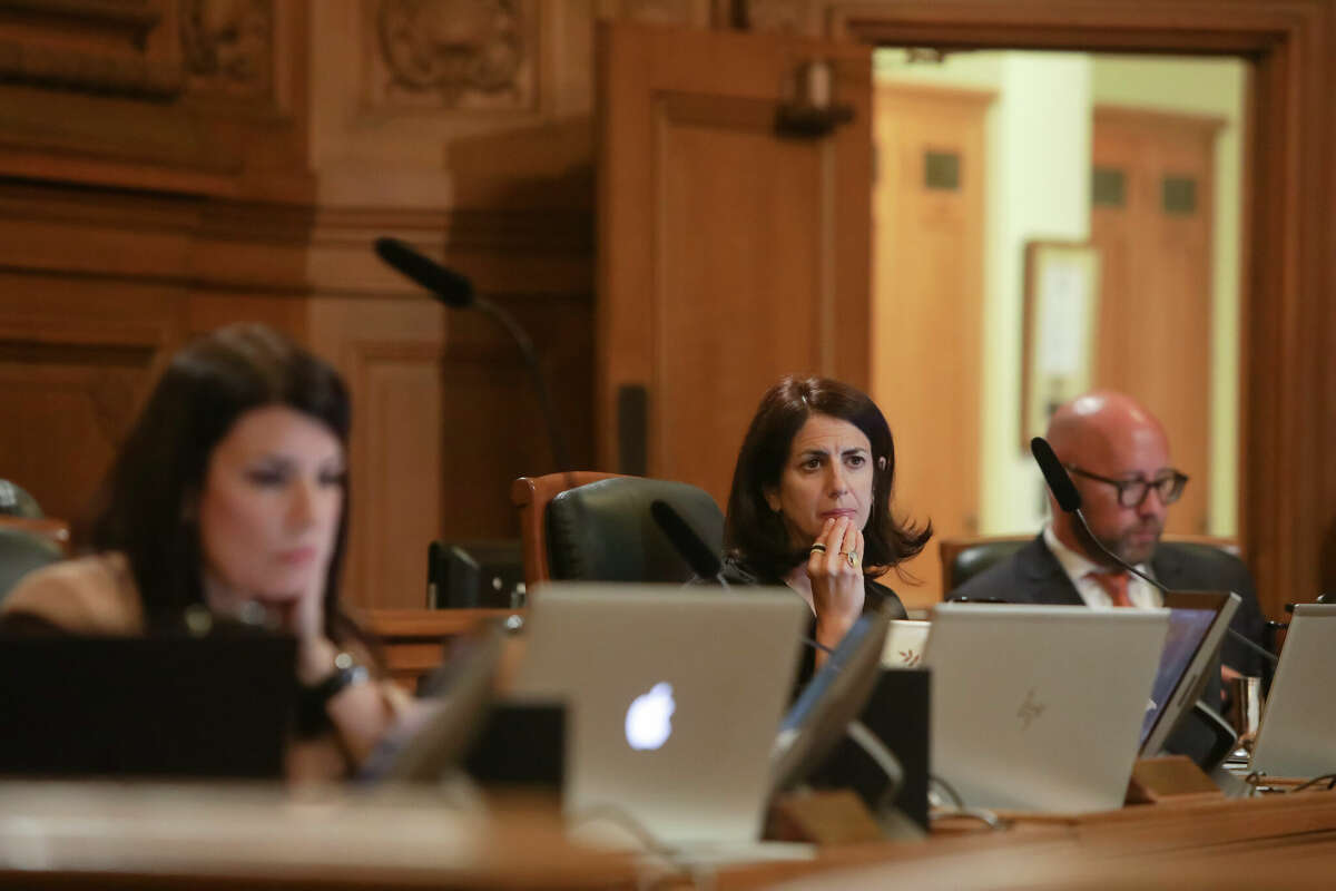 San Francisco Supervisors Catherine Stefani, left, Hillary Ronen and Rafael Mandelman listen to public comment at a board meeting in September.