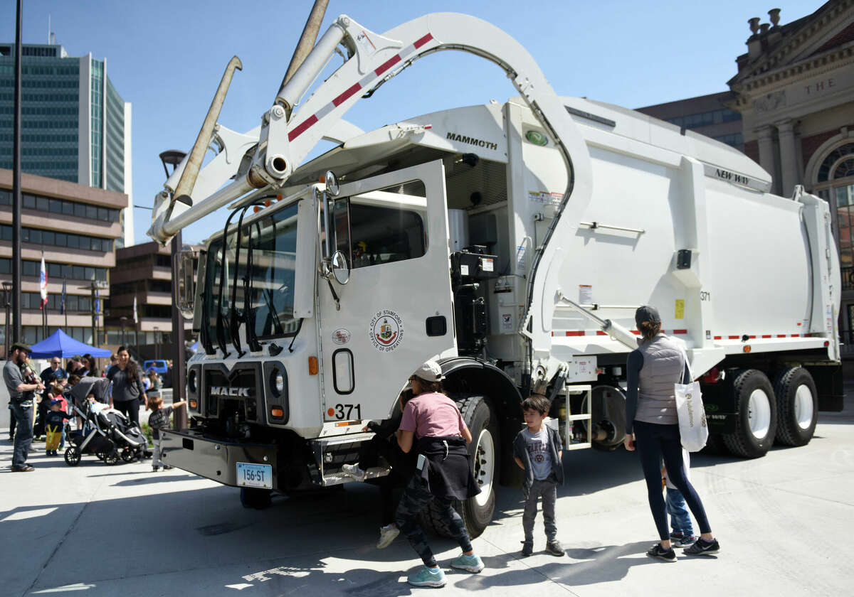 A Mack waste disposal truck on display at an April 2022 "Touch a Truck" event in Stamford. The Stamford startup Roundtrip EV is building an "everything but the driver" service to help waste haulers phase out diesel trucks in favor of emerging all-electric models.