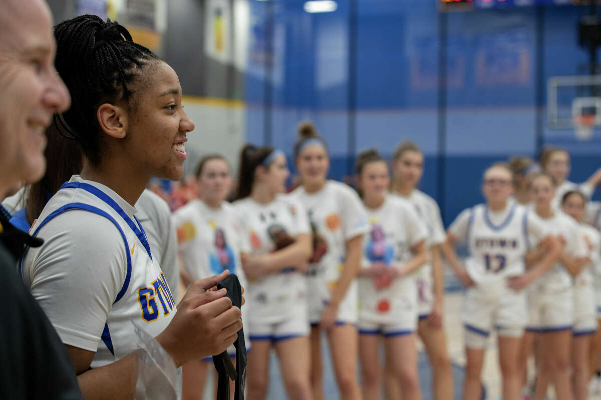 KK Arnold poses with her McDonald's All-American game jersey before her game at Germantown High School in Germantown, Wisconsin Tuesday, Feb. 14, 2023.