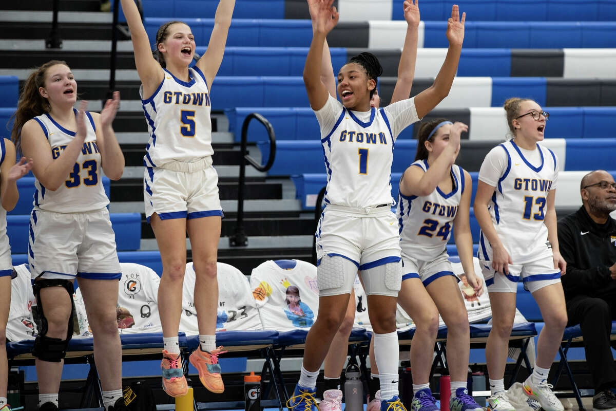 KK Arnold sits on the bench cheering on teammates at their game at Germantown High School in Germantown, Wisconsin Tuesday, Feb. 14, 2023.