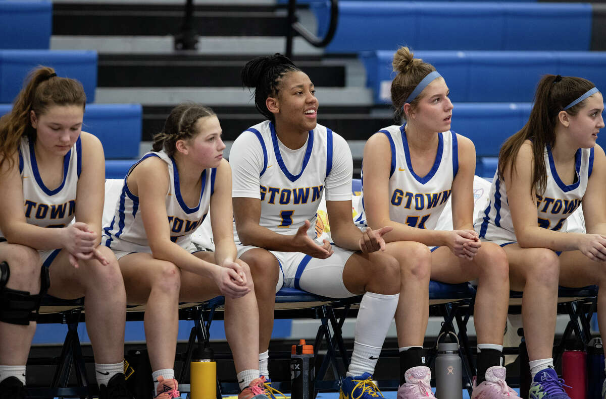 KK Arnold sits on the bench cheering on teammates at their game at Germantown High School in Germantown, Wisconsin Tuesday, Feb. 14, 2023.