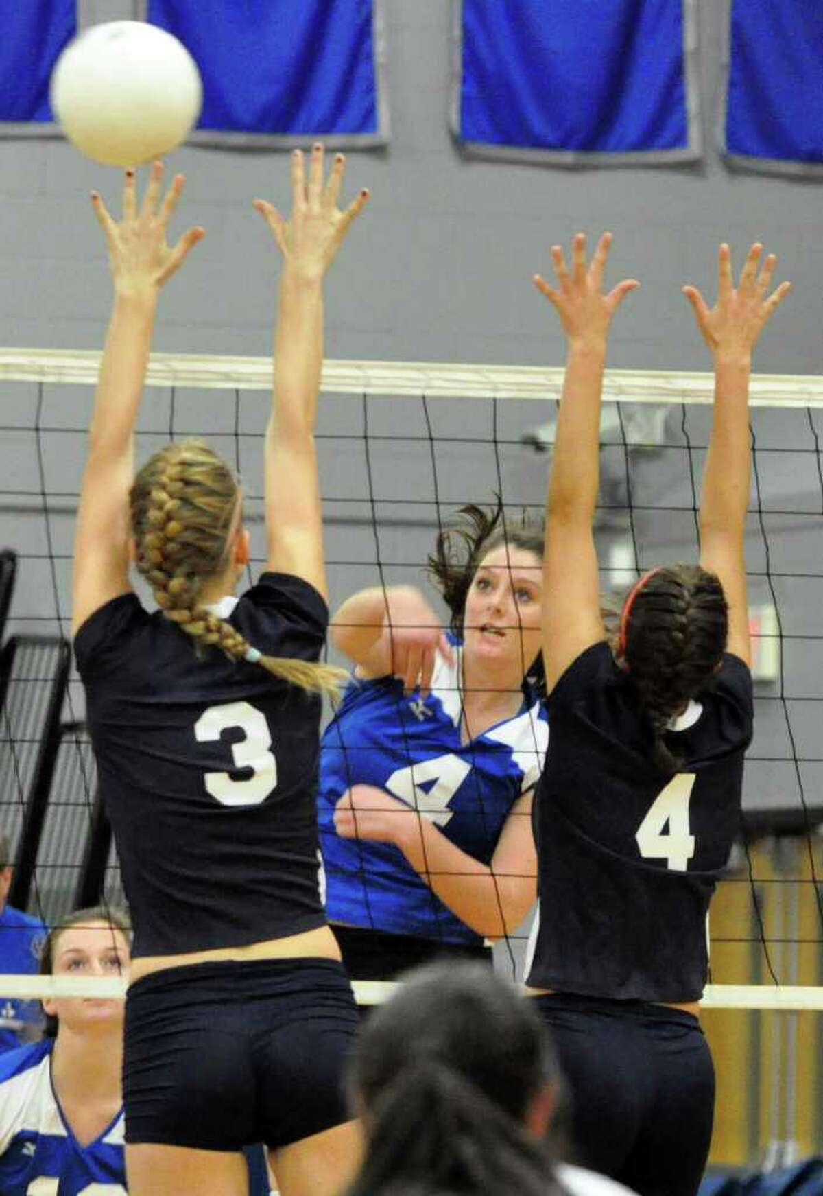 Fairfield Ludlowe's Dillon Casey sends the ball over the net to Staples' defenders Augie Gradoux-Matt and Lucy Stanley during the girls volleyball game at Ludlowe on Wednesday, Oct. 13, 2010.
