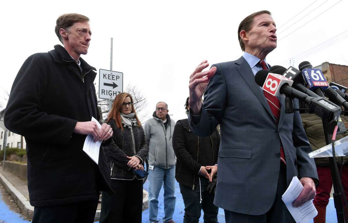 New Haven Mayor Justin Elicker, left, listens to U.S. Sen. Richard Blumenthal announce $400,000 in federal funds for implementing the Safe Routes for All plan at the intersection of Derby Avenue, George Street and Norton Street in New Haven.