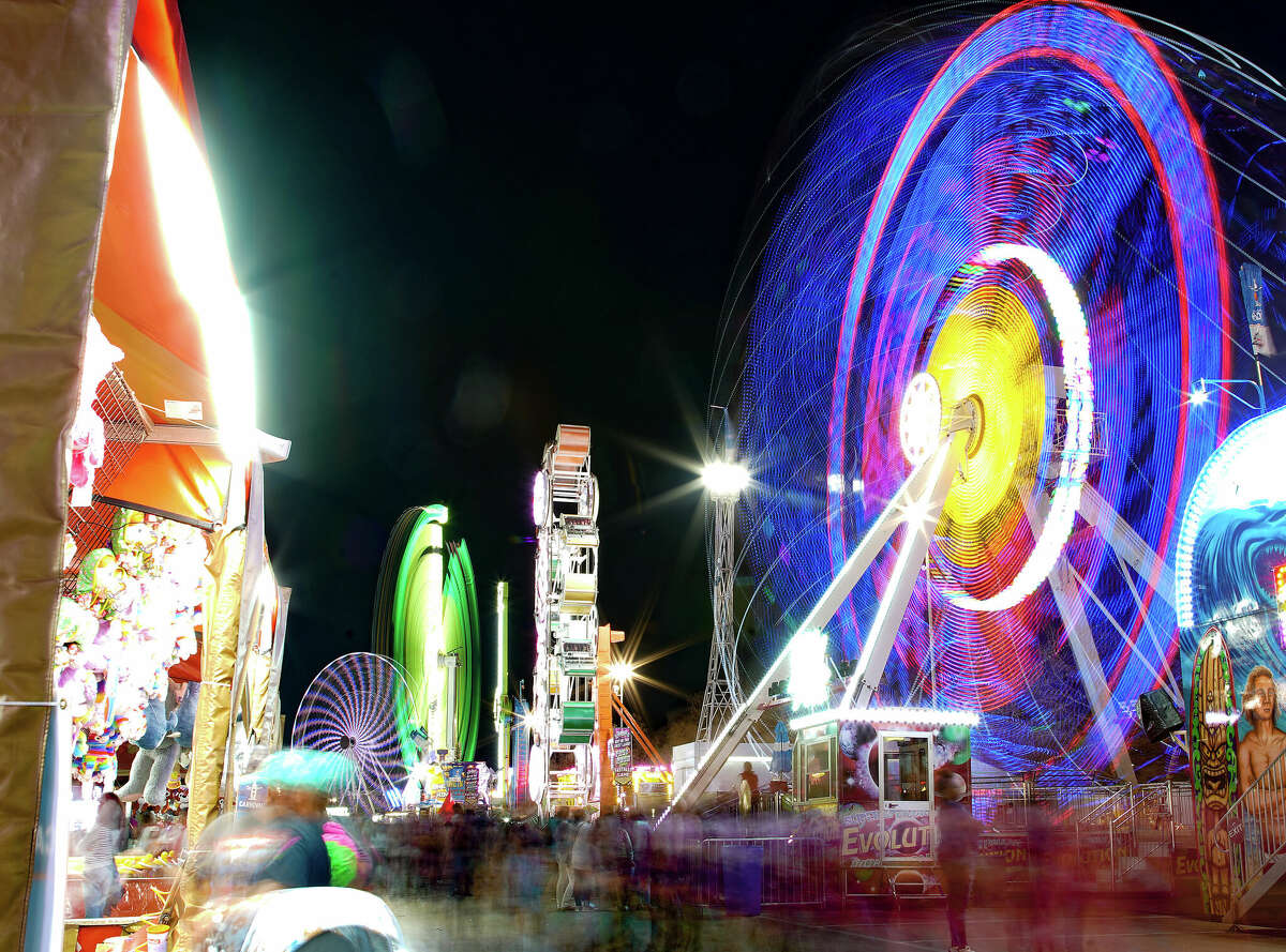Long exposure of attendees of the Houston Livestock and Rodeo flood into the carnival area on Tuesday, March 15, 2022.