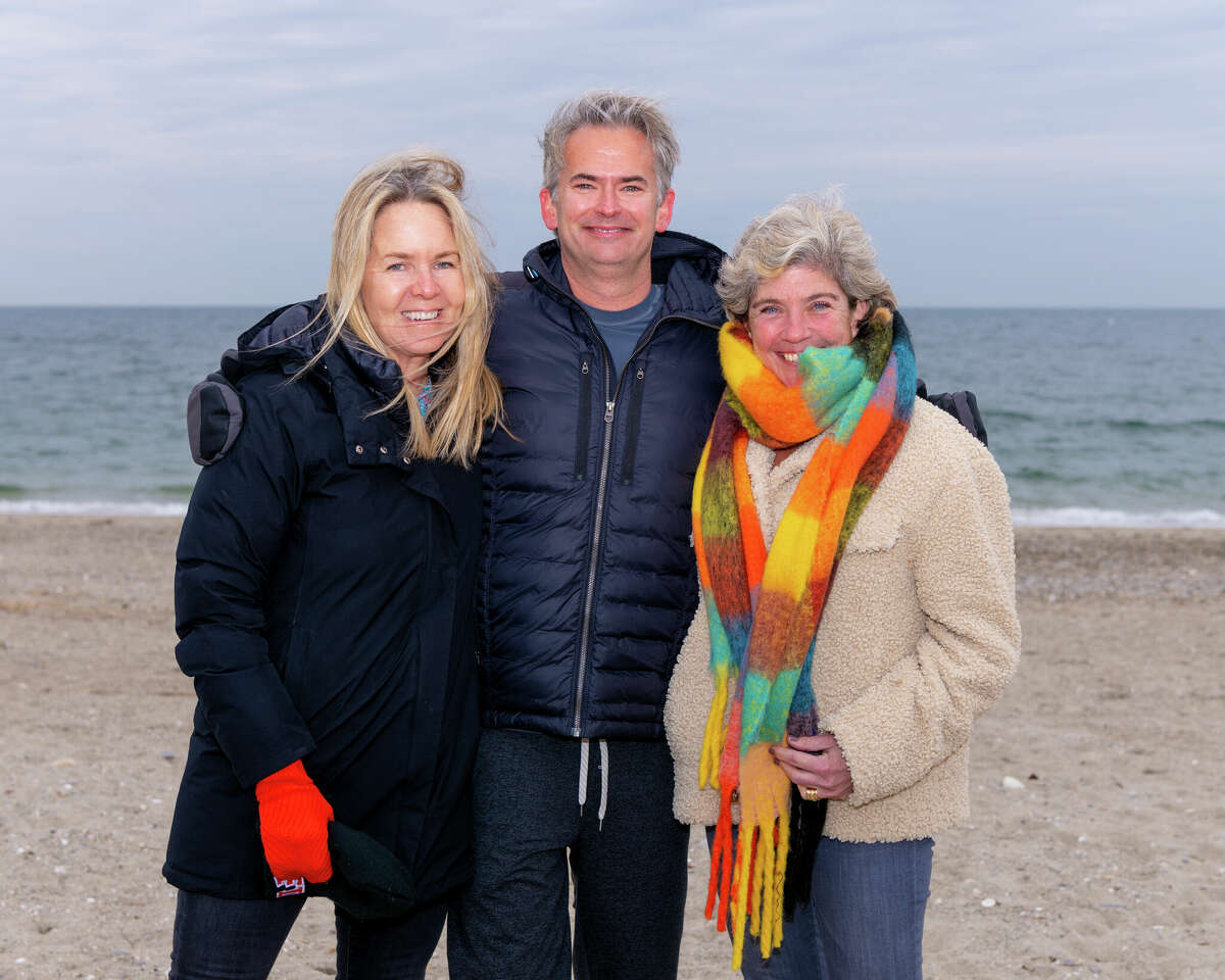 Westport Second Selectwoman Andrea Moore, Synchrony CEO and President Brian Doubles and Westport First Selectwoman Jen Tooker gather at Compo Beach to support the Synchrony “Doubles Dive,” a polar plunge for charity.