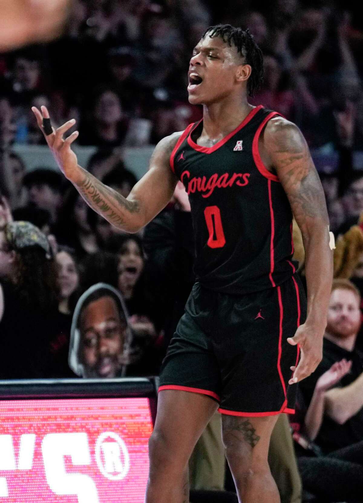 Houston guard Marcus Sasser (0) reacts after hitting a 3-pointer against Tulane during the first half of an NCAA college basketball game Wednesday, Feb. 22, 2023, in Houston.