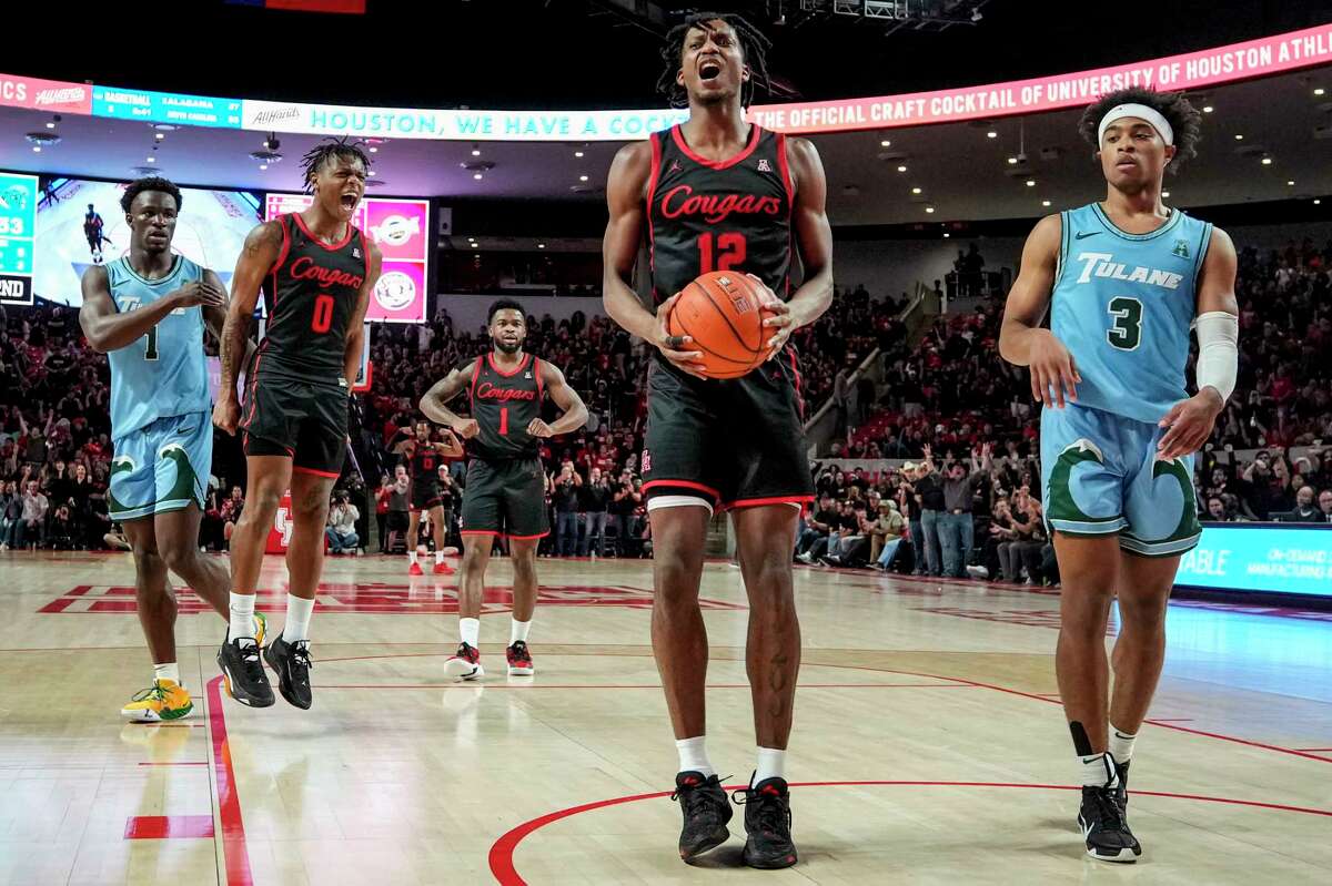 Houston guards Tramon Mark (12) and Marcus Sasser (0) react after Mark scored against Tulane guard Jalen Cook (3) during the second half of an NCAA college basketball game Wednesday, Feb. 22, 2023, in Houston.