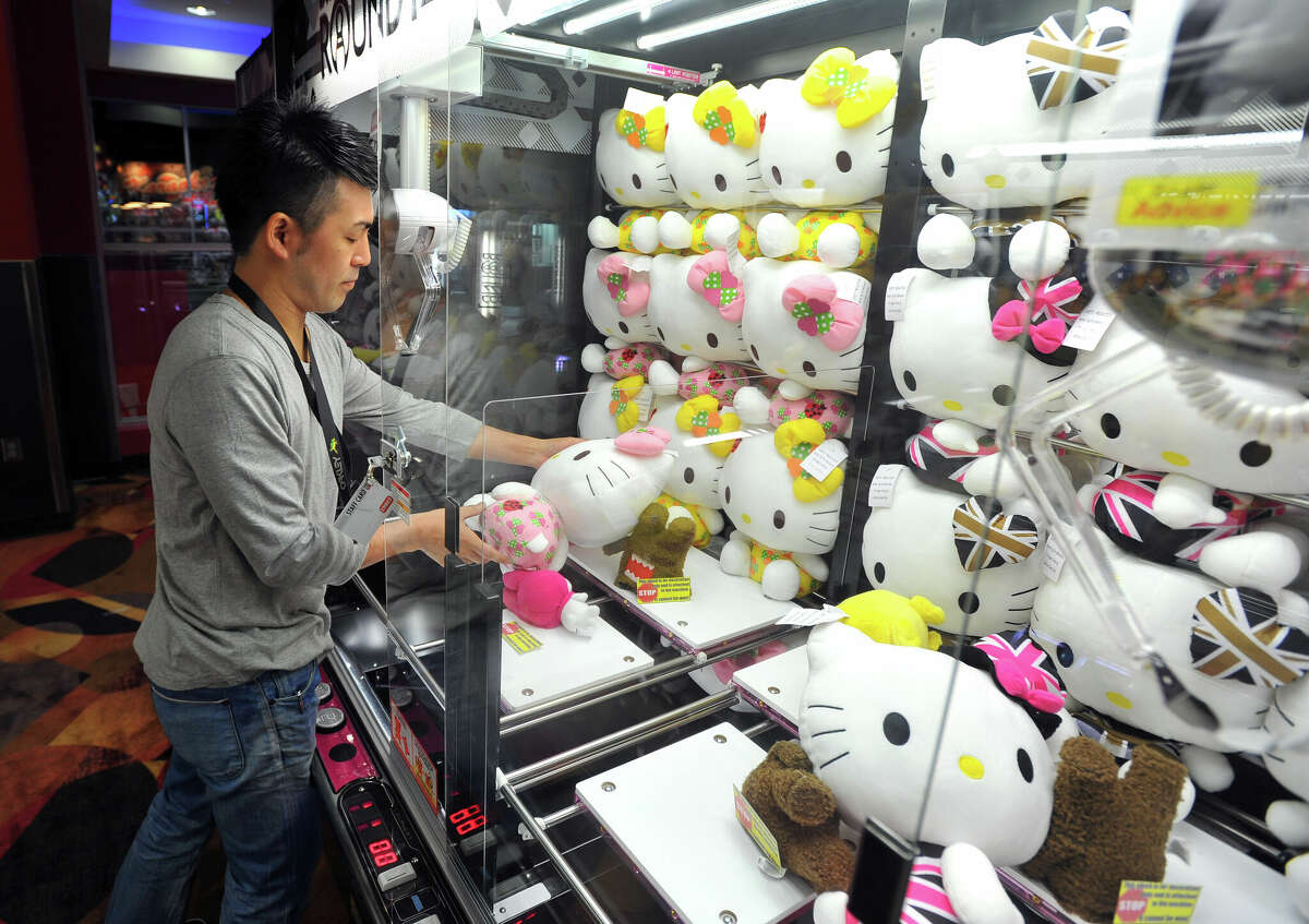 Round1 staff restock a plushie crane game.