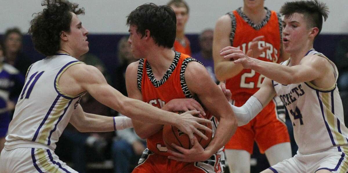 Routt's Nolan Turner (left) and Bryson Mossman trap Greenfield-Northwestern's Talon Albrecht during a boys' basketball game at the Routt Dome in Jacksonville Wednesday night.