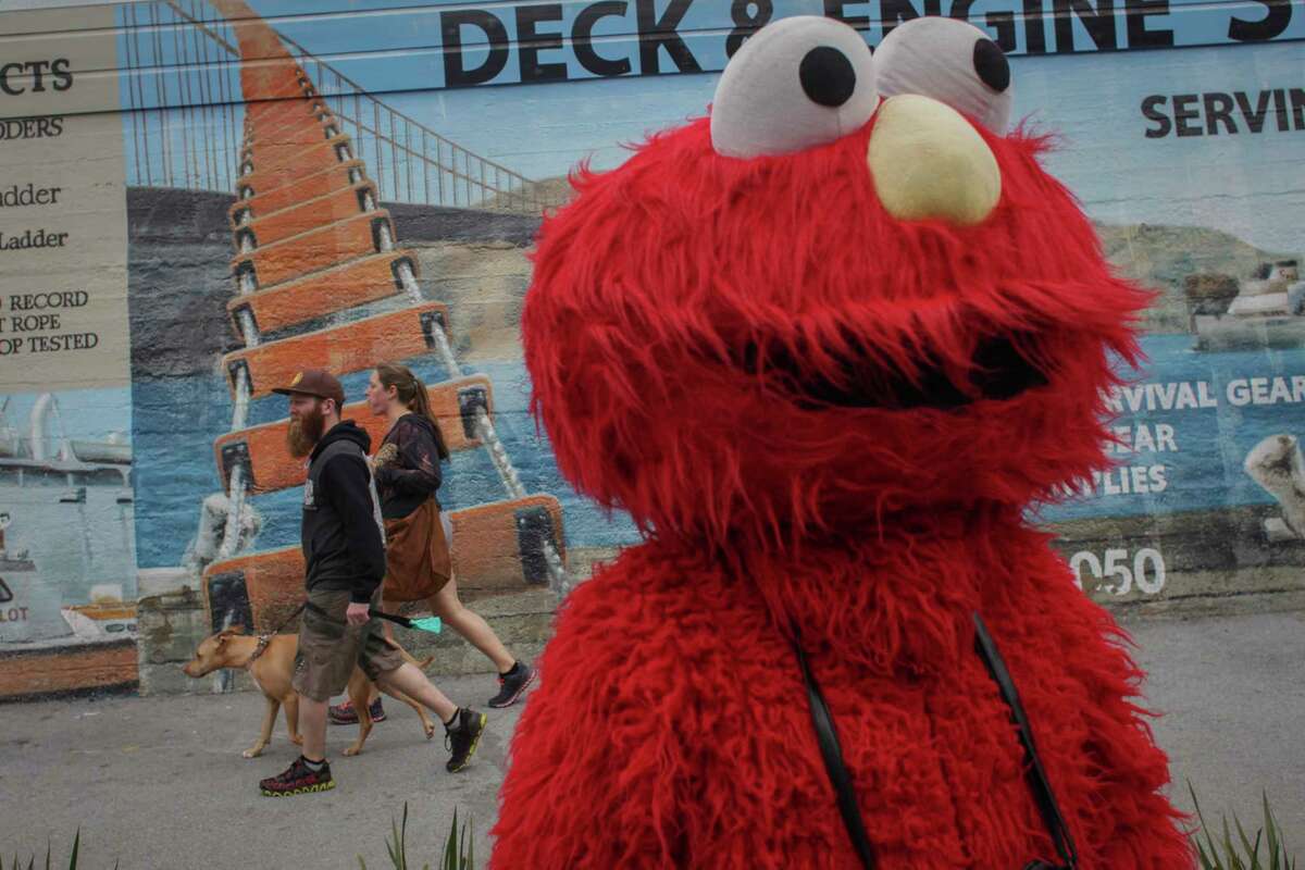 Dan Sandler, dressed as Elmo, waits for tourists to pass by in Fisherman's Wharf on March 5, 2014. 