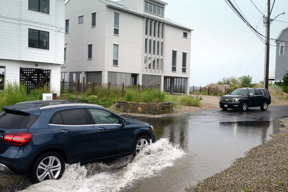 High tide brought the waters of Long Island Sound onto a short stretch of Fairfield Beach Rd., in Fairfield, Conn. Aug. 22, 2021. As Tropical Storm Henri passed farther to the east, most of coastal Fairfield County experienced an ordinary rainy day on Sunday.