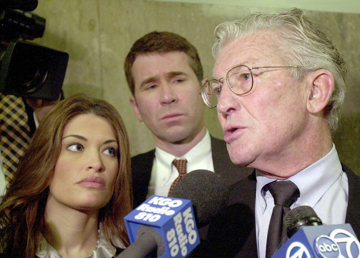 San Francisco District Attorney Terence Hallinan speaks to the press after the arraignment of Marjorie Knoller and Robert Noel for the dog-mauling death of Diane Whipple on March 29, 2001. Assistant DAs Jim Hammer, center, and Kimberly Guilfoyle look on.