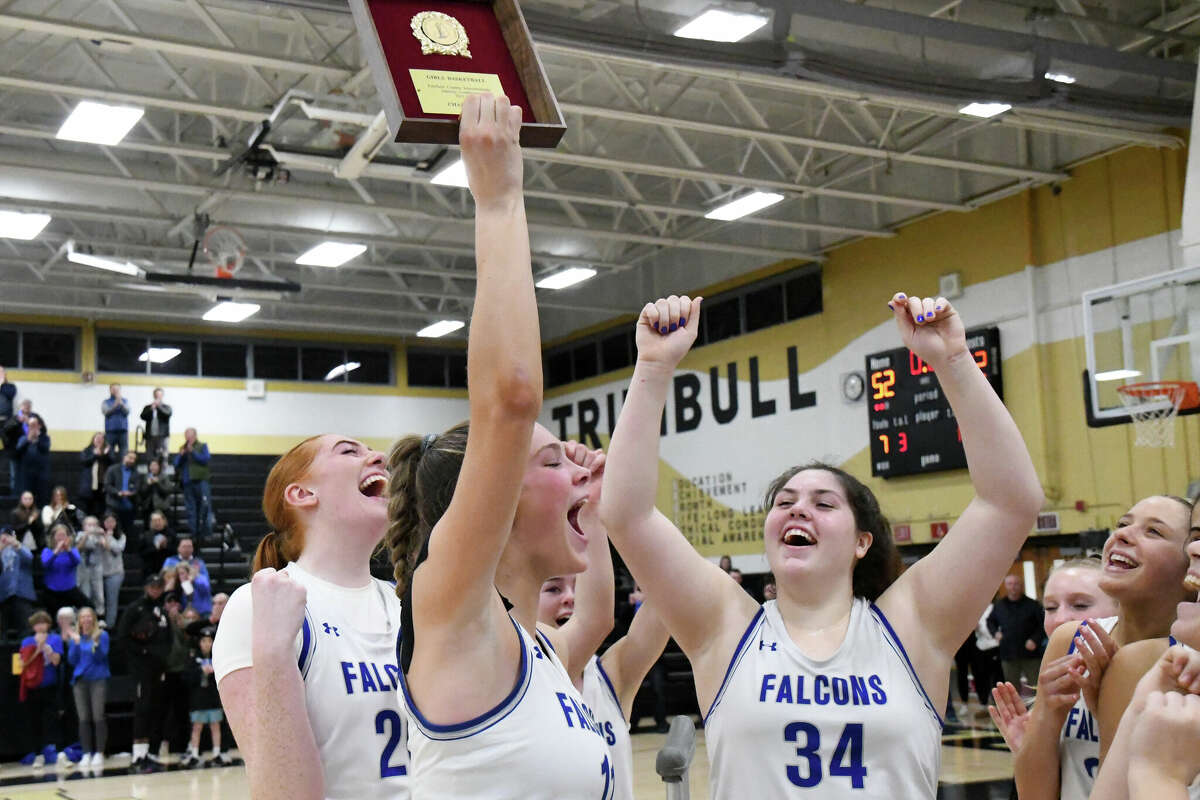 Fairfield Ludlowe's Kaleigh Sommers holds up the FCIAC girls basketball championship plaque after Ludlowe beat St. Joseph in the FCIAC title game at Trumbull High School, Trumbull on Thursday, February 23, 2023.