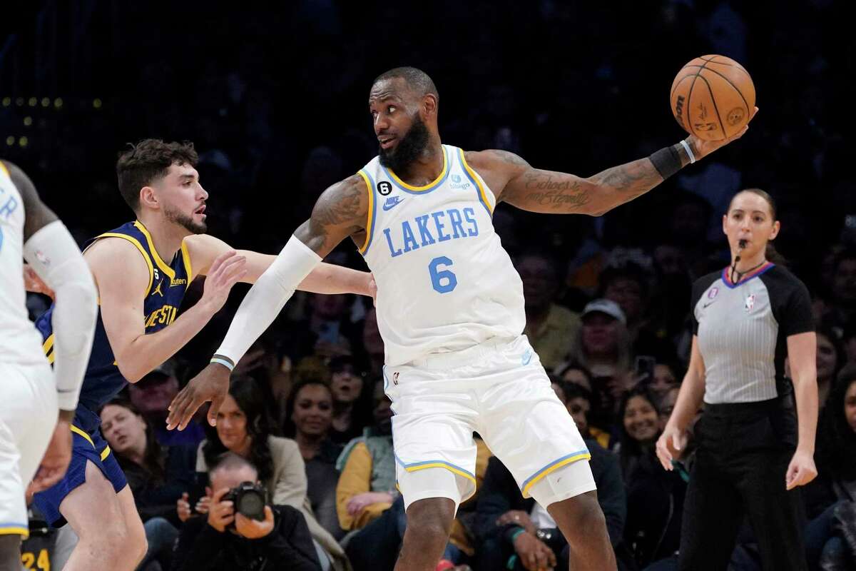 Los Angeles Lakers forward LeBron James, right, tries to get by Golden State Warriors guard Ty Jerome during the second half of an NBA basketball game Thursday, Feb. 23, 2023, in Los Angeles. (AP Photo/Mark J. Terrill)