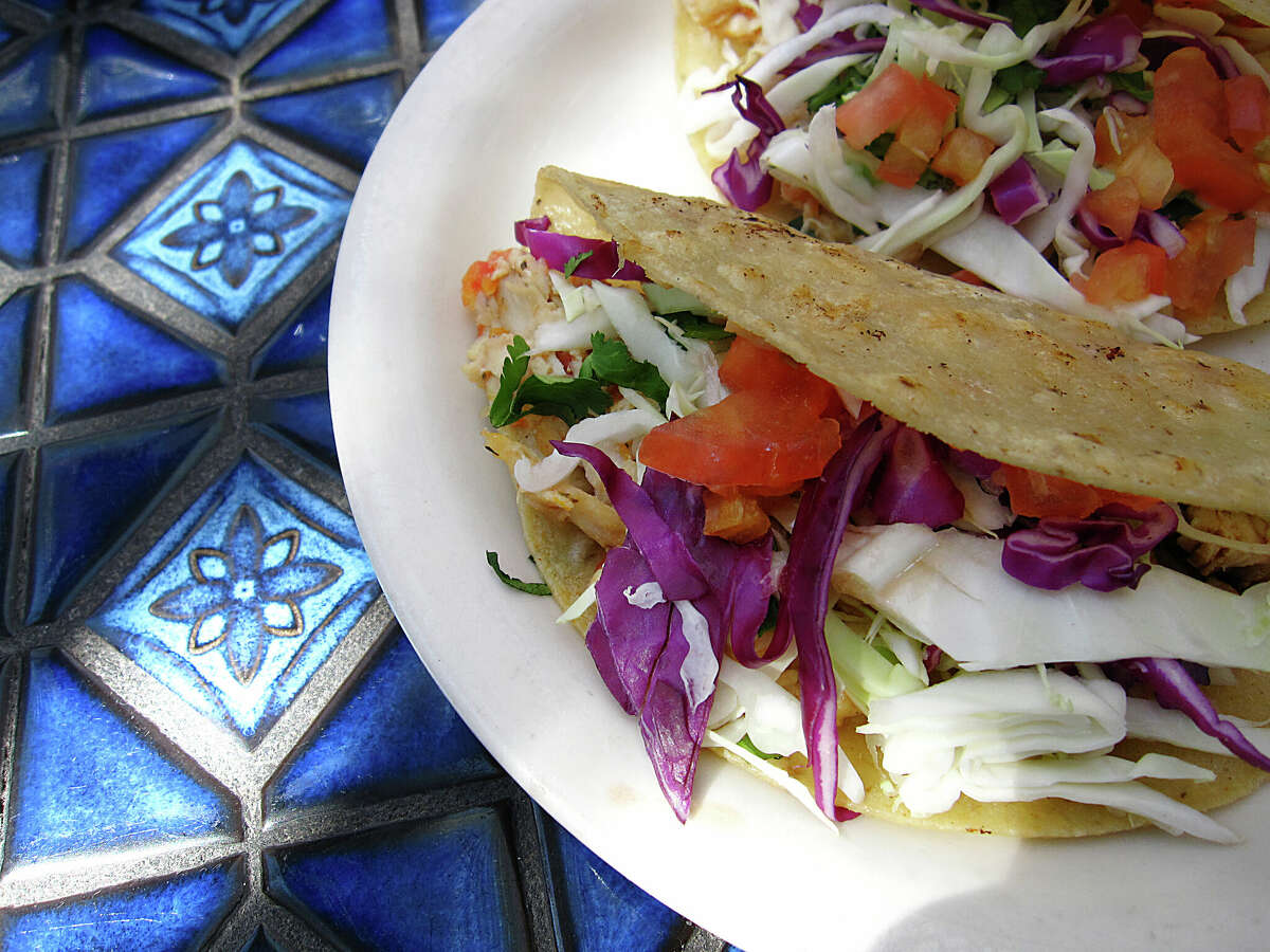 Mahi-mahi fish tacos incorporate cabbage, tomatoes and onions on lightly fried corn tortillas at La Fogata, one of 10 places to get good fish tacos for Lent in San Antonio.