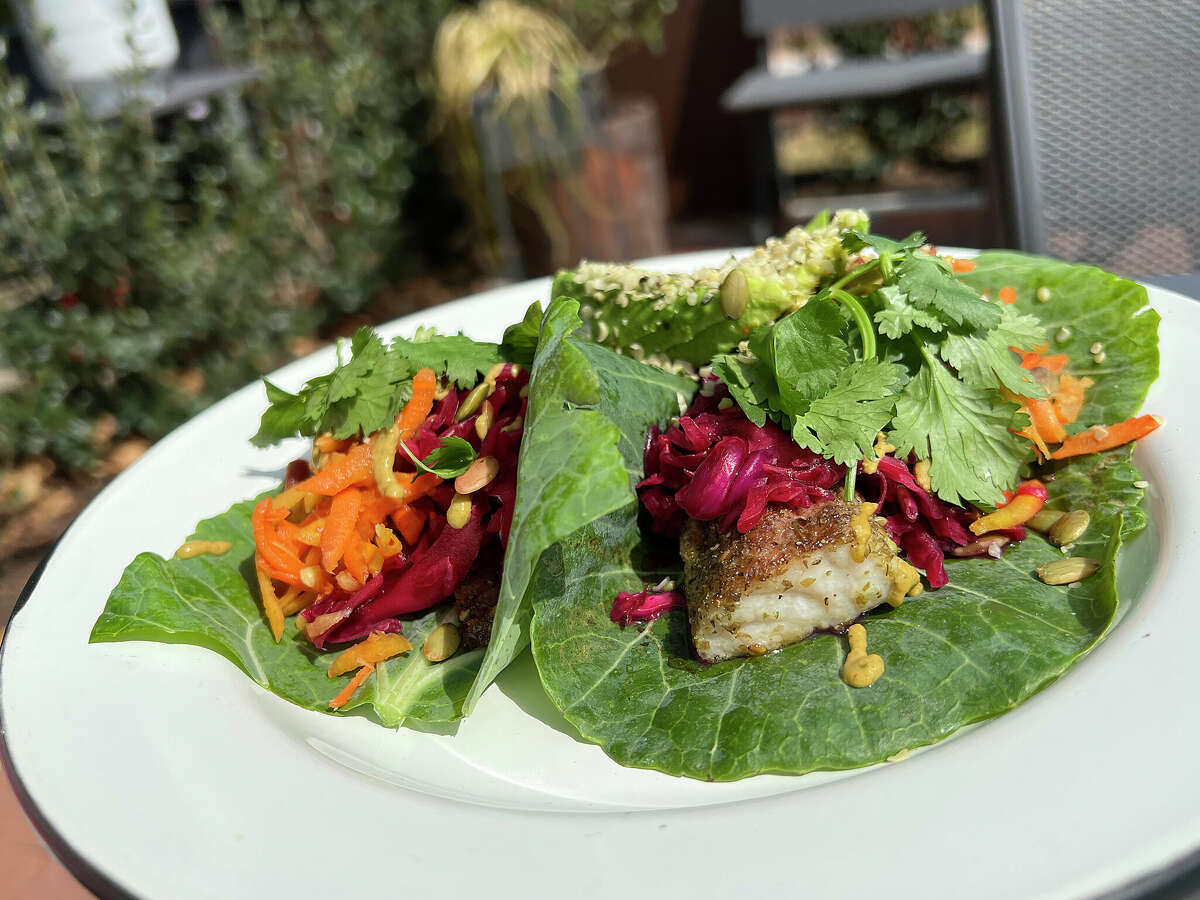 Fish tacos incorporating cabbage-fennel slaw, guacamole, pickled carrots and hemp-seed salsa can be ordered with collard green leaves instead of tortillas at Pharm Table, one of 10 places to get good fish tacos for Lent in San Antonio.