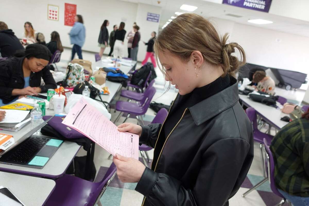 Sabine Pass senior Claire Londenberg reviews judges' comments on her extemporaneous informative speech at the Port Neches-Groves Invitational UIL Academic Meet. Photo taken Feb. 11, 2023. Photo by Olivia Malick/The Enterprise.