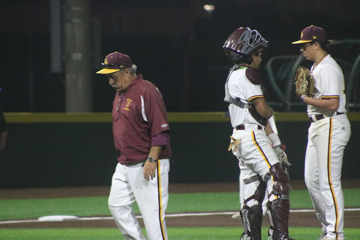 Deer Park head coach Chris Rupp finishes a trip to the mound Thursday night after talking with Anthony Ramirez.