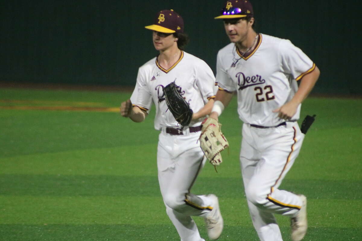 Dillon Mancha trots off the field with a teammate after making a nice inning-ending catch of a hard-hit ball to right field Thursday night.