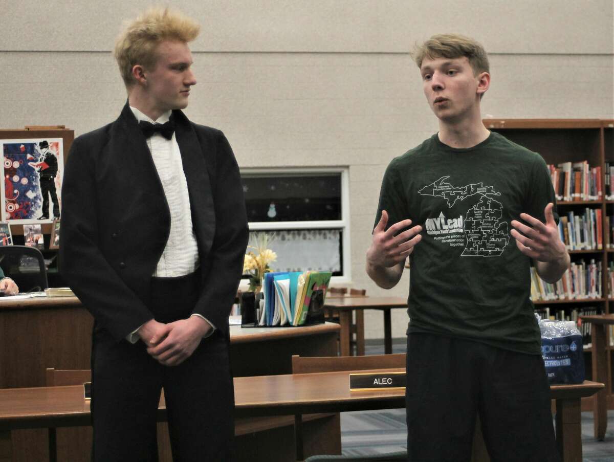 Manistee High School juniors Drew Mendians (left) and Luke Senters discuss their trip to the MYLead Conference during a Feb. 8 Manistee Area Public Schools Board of Education meeting.