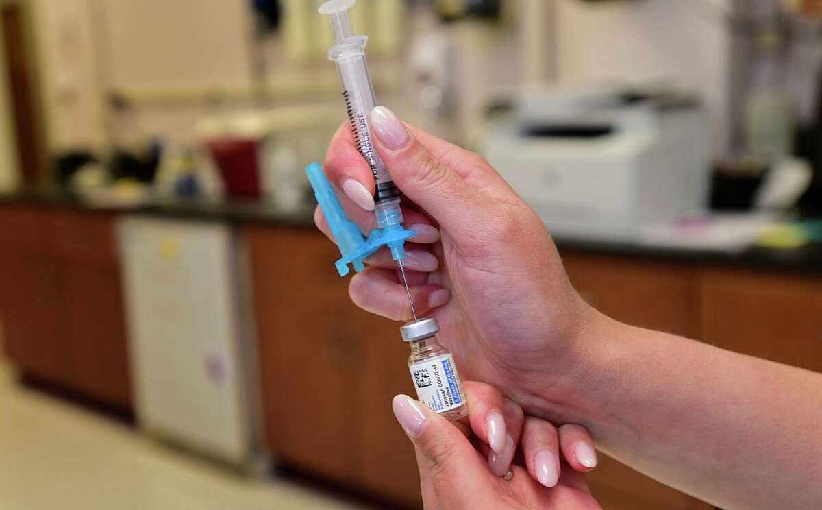 A nurse draws up a vaccine in Norwalk in 2021.