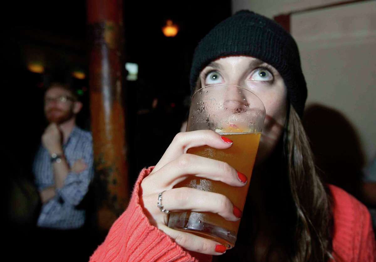 Jessica Nemire drinks a beer while watching the San Francisco Giants at Oracle Park in San Francisco. Some beer prices are coming down at the ballpark. 