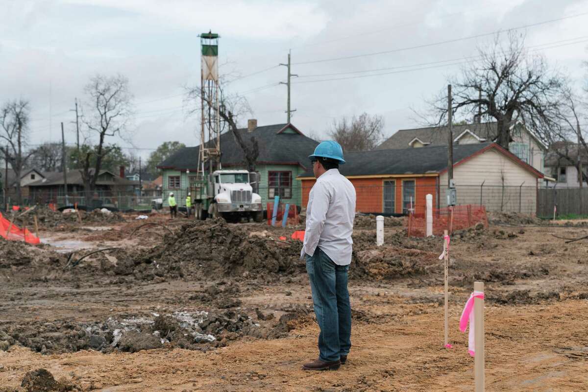 Adolfo Loredo, an independent contractor from RB Dillard Group, watches over the construction site of a CoHousing community in Houston, Texas on Friday, Feb. 24, 2023.