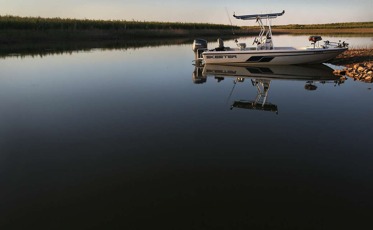 A fishing boat is reflected in the still waters on a branch of the O.H. Ivie Reservoir, at Concho Recreation Area, on Wednesday, Sept. 4, 2013.