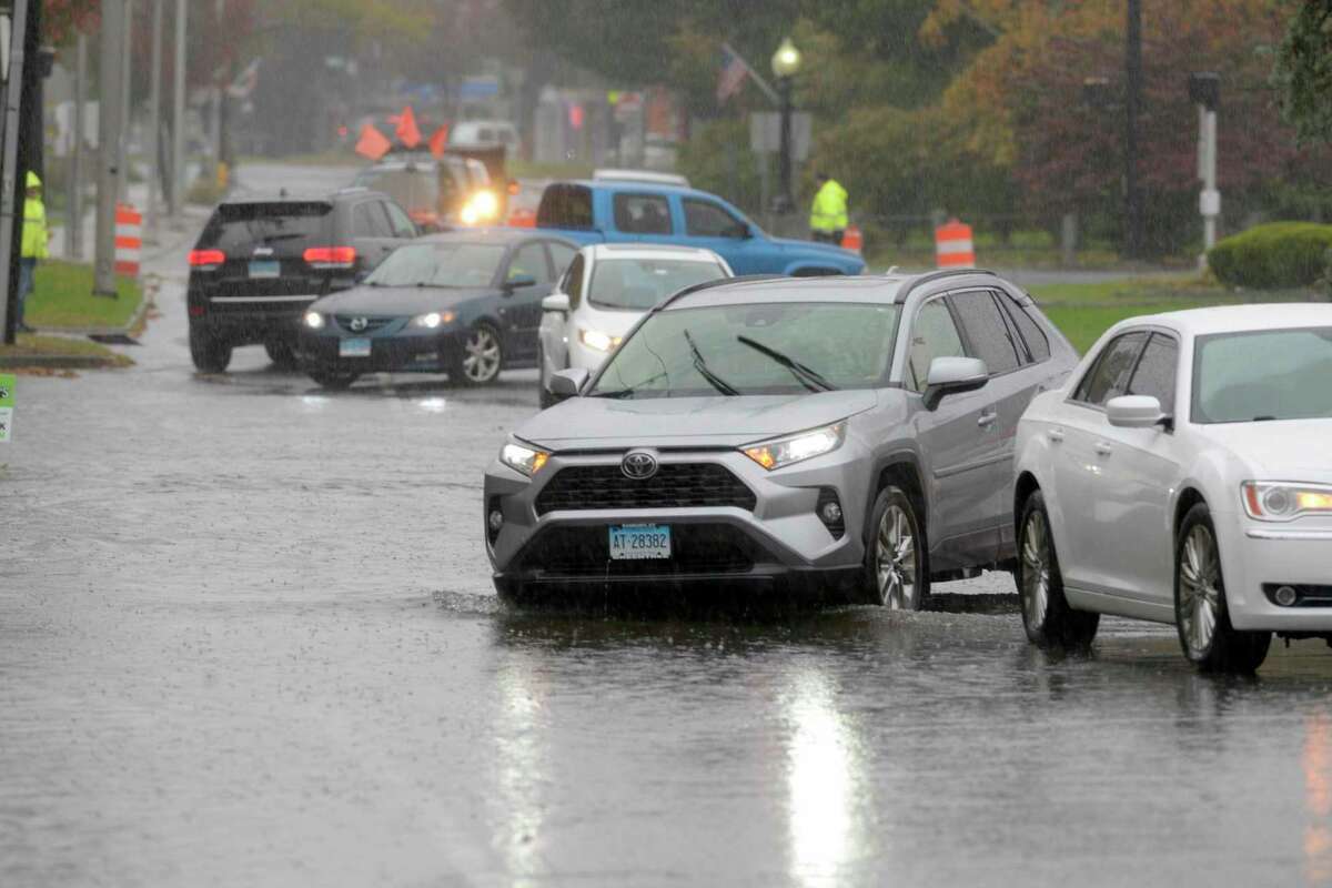 Flooding impedes traffic at Elmwood Place and Main Street in Danbury, Conn., during a storm on Tuesday, Oct. 26, 2021. 