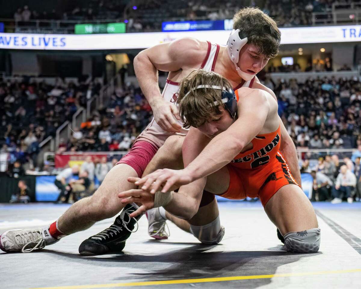 Owen Hicks, top, of Fonda/Johnstown, wrestles against Austin Chase, of Falconer/Cassadaga Valley, during the 145-pound class of the state championships on Friday, Feb. 24, 2023, at the MVP Arena in Albany, NY.