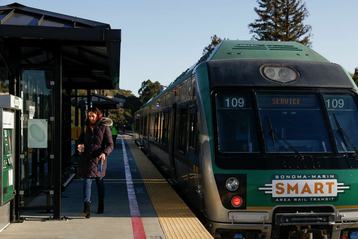 Commuters exit the Sonoma-Marin Area Rapid Transit train at Larkspur Station.