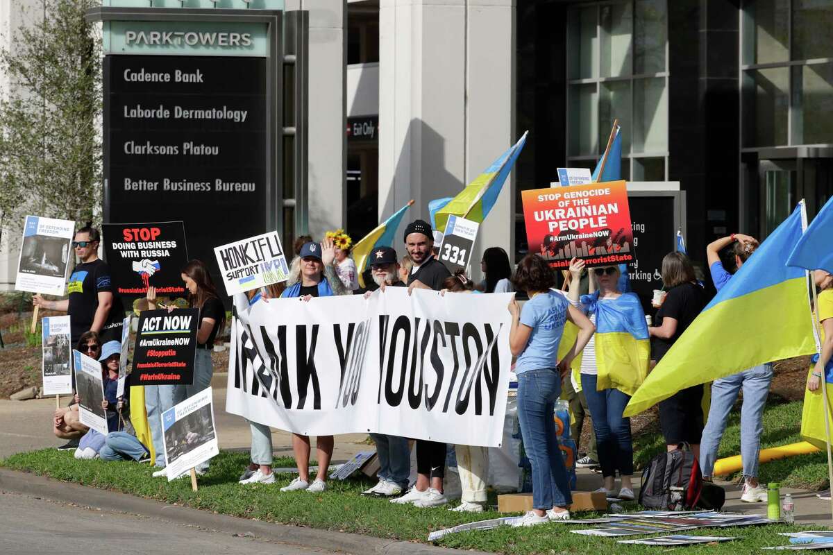 Protestors wave Ukrainian flags and pro-Ukraine signs to motorists as they drive by outside of the offices of the Consulate General of the Russian Federation, on the one year anniversay of the Russian invasion of Ukraine Friday, Feb. 24, 2023 in Houston.