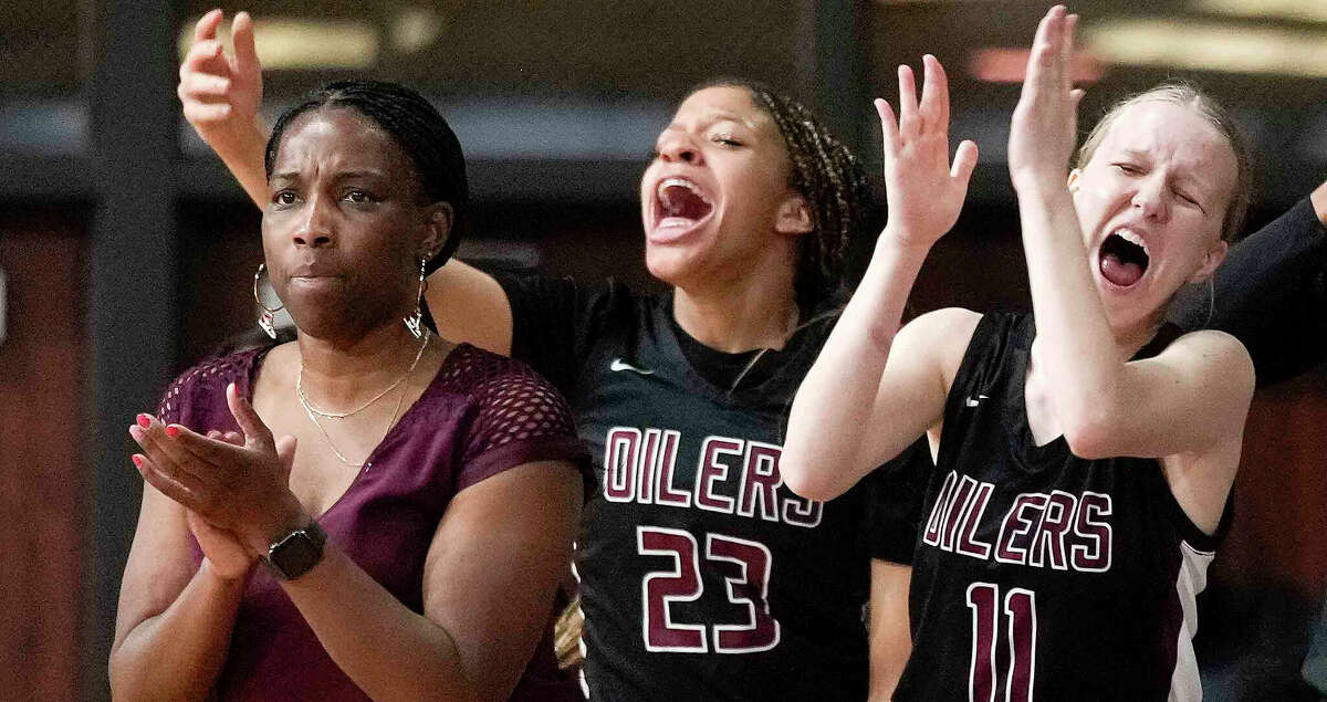 Pearland head coach Jere' Adams, left, Ava Haynes (23) and Emily Andersin (11) cheer a basket during the first half of a Region III-6A semifinal high school basketball playoff game against Katy, Friday, Feb. 24, 2023, in Houston.